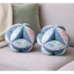 A pair of decorative balls in a denim color with multiple accents – soft velvet fabric